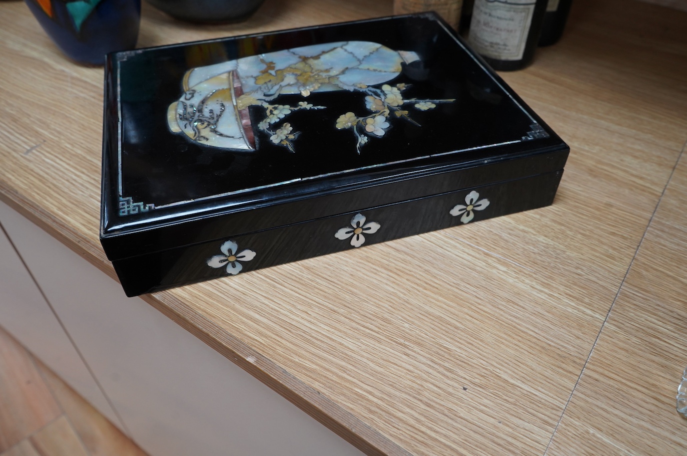 A South East Asian mother of pearl inlaid lacquered box, 36cm. Condition - fair